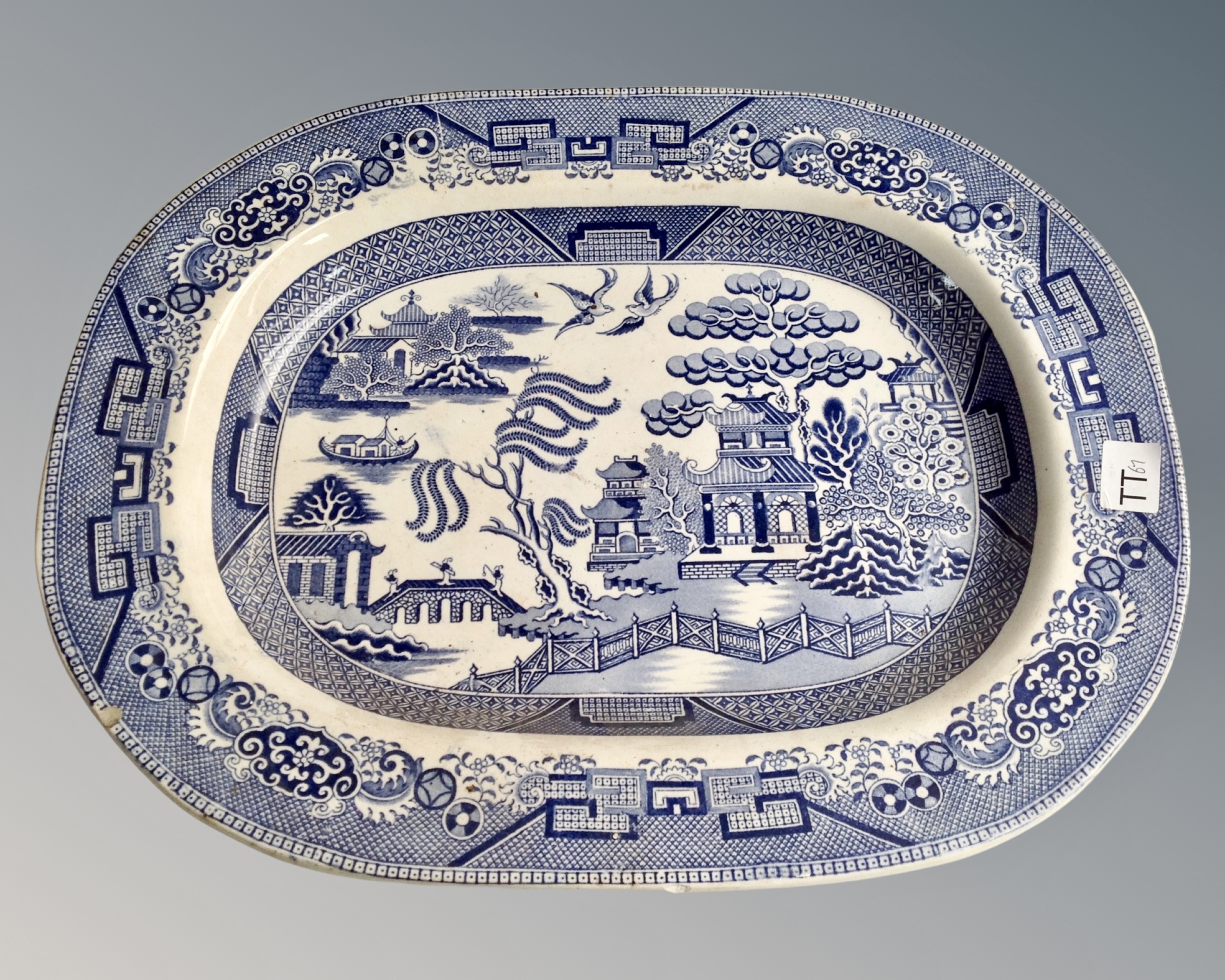 A 19th century blue and white willow pattern meat plate.