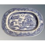 A 19th century blue and white willow pattern meat plate.