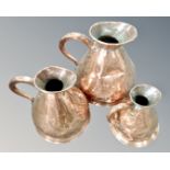 A graduated set of three Victorian copper flagons.