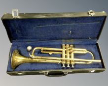 A brass Melody Maker trumpet with mouthpiece, in hard carry case.