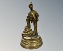A brass figure of a miner.