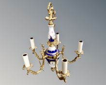 A continental gilt brass and painted porcelain five branch chandelier.