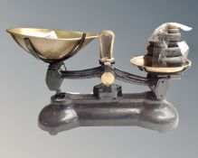 A set of cast iron and brass scales with weights.