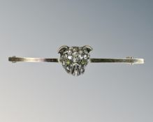 An antique bar brooch modelled as a diamond encrusted pug's head, set with peridot eyes,