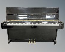 A Steinbach upright overstrung piano in ebonised gloss case, with tuner and keys.