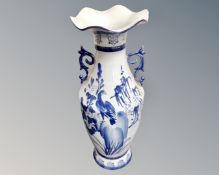 A large Oriental style blue and white porcelain vase.