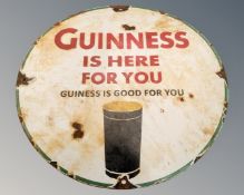 A Guinness Is Here For You enamelled metal circular sign.