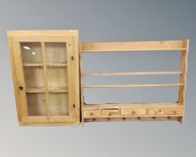 A glazed pine wall cabinet and a plate rack
