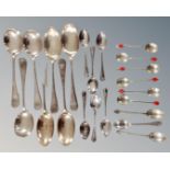 A quantity of assorted plated spoons together with three silver teaspoons.