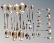 A quantity of assorted plated spoons together with three silver teaspoons.