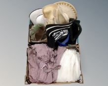 Two boxes containing two lady's dresses and a quantity of hats including straw and feather examples.