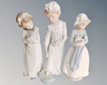 Three Nao figures of children in night dress (tallest 28cm,