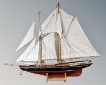 A model of a two masted sailing ship on stand entitled 'Bluenose'.