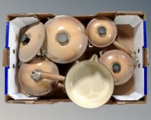 A box containing five Le Creuset cast iron enamelled pans with lids.
