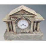 An onyx eight day mantel clock with enamelled dial.