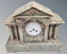 An onyx eight day mantel clock with enamelled dial.