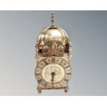 A reproduction brass lantern clock.