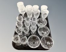 A tray containing assorted glass drinking vessels together with a set of four glass dishes.