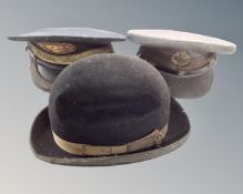 A vintage RAF cap with cap badge, another Stationmaster cap and a Harrods of London gentleman's hat.