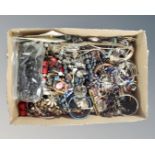 A box of various bracelets and bangles together with a box of assorted earrings.