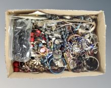 A box of various bracelets and bangles together with a box of assorted earrings.
