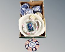 A box containing blue and white willow pattern teapot and plates, cheese dish and cover,