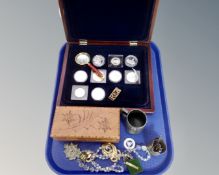 A tray containing a coin collector's box containing coins, wooden trinket box, costume jewellery,