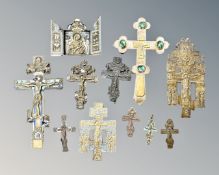 A group of eastern orthodox brass and enamelled crucifixes including one set with green faceted