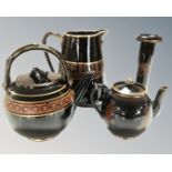 A tray of Greek style ceramics comprising of two teapots, a jug and a candlestick.