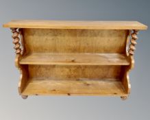 A 19th century oak and pine open bookcase with twist column supports