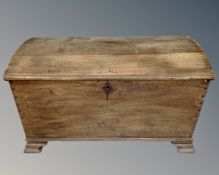 A 19th century oak dome topped shipping trunk.