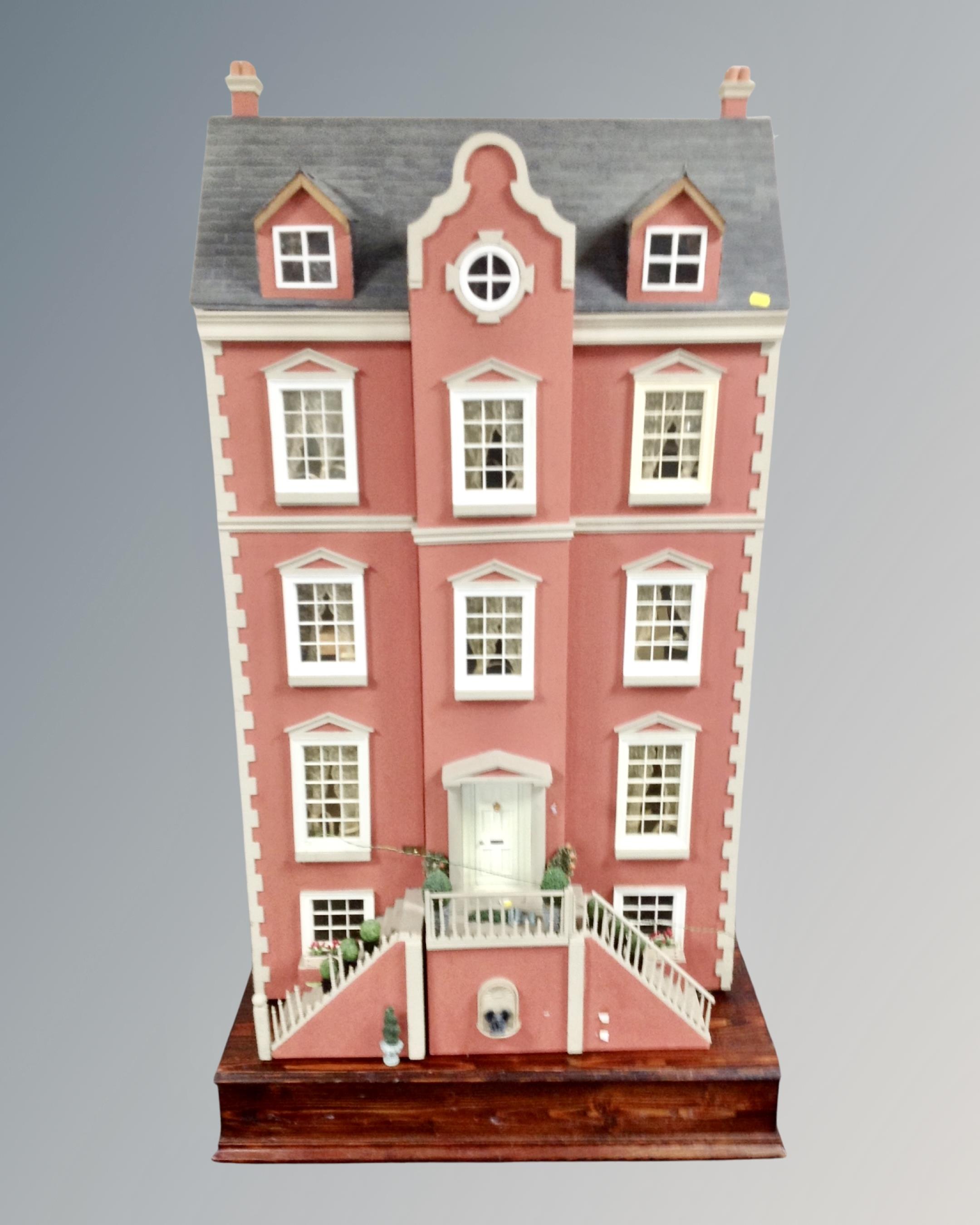 An impressive Georgian style five story doll's house together with a large quantity of doll's house