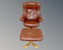 A 20th century Danish swivel armchair and stool upholstered in brown leather