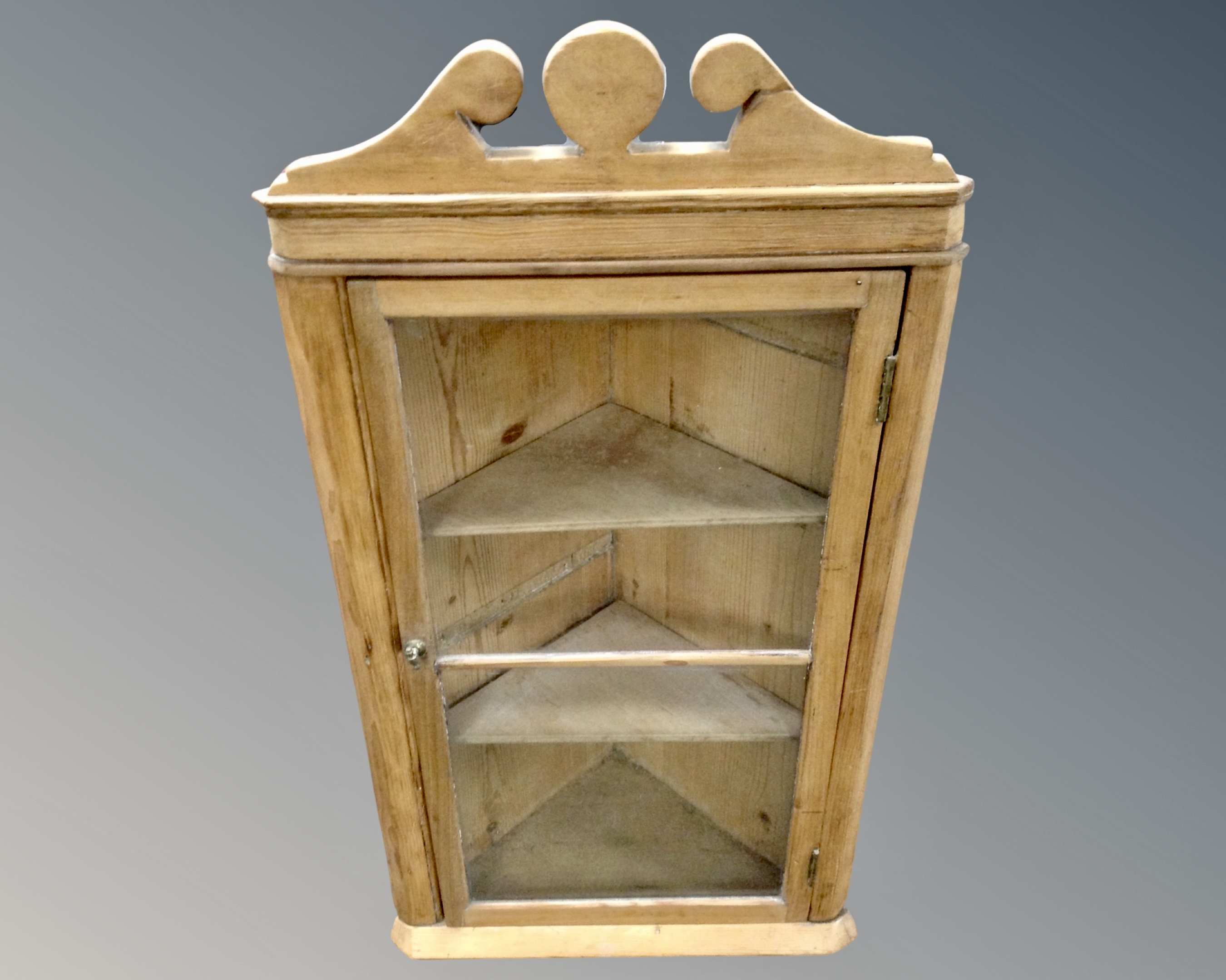 An antique pine glazed door hanging corner cabinet.