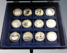 A set of twelve commemorative World War II coins in case