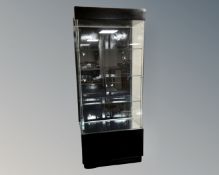 A free standing shop display cabinet with lights.