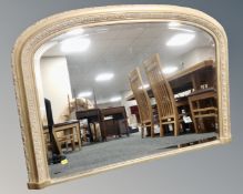 A Victorian style bevel edged overmantel mirror in gilt frame.