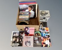 A box of vinyl records and singles including Michael Jackson, Elvis Presley etc.