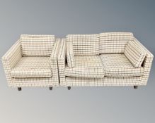 A 20th century Danish two seater settee and armchair in checkered fabric