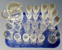 A tray containing assorted cut glass and lead crystal drinking vessels together with two jugs.