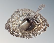 A pierced silver heart shaped dish, length 11 cm together with a plated caddy spoon.