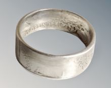 A gent's silver ring made from an American half dollar coin.