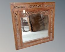 A continental hardwood mirror in decorative frame.