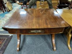 An 19th century mahogany flap sided library table fitted a drawer