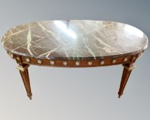 A French oval marble topped coffee table with gilt and porcelain mounts