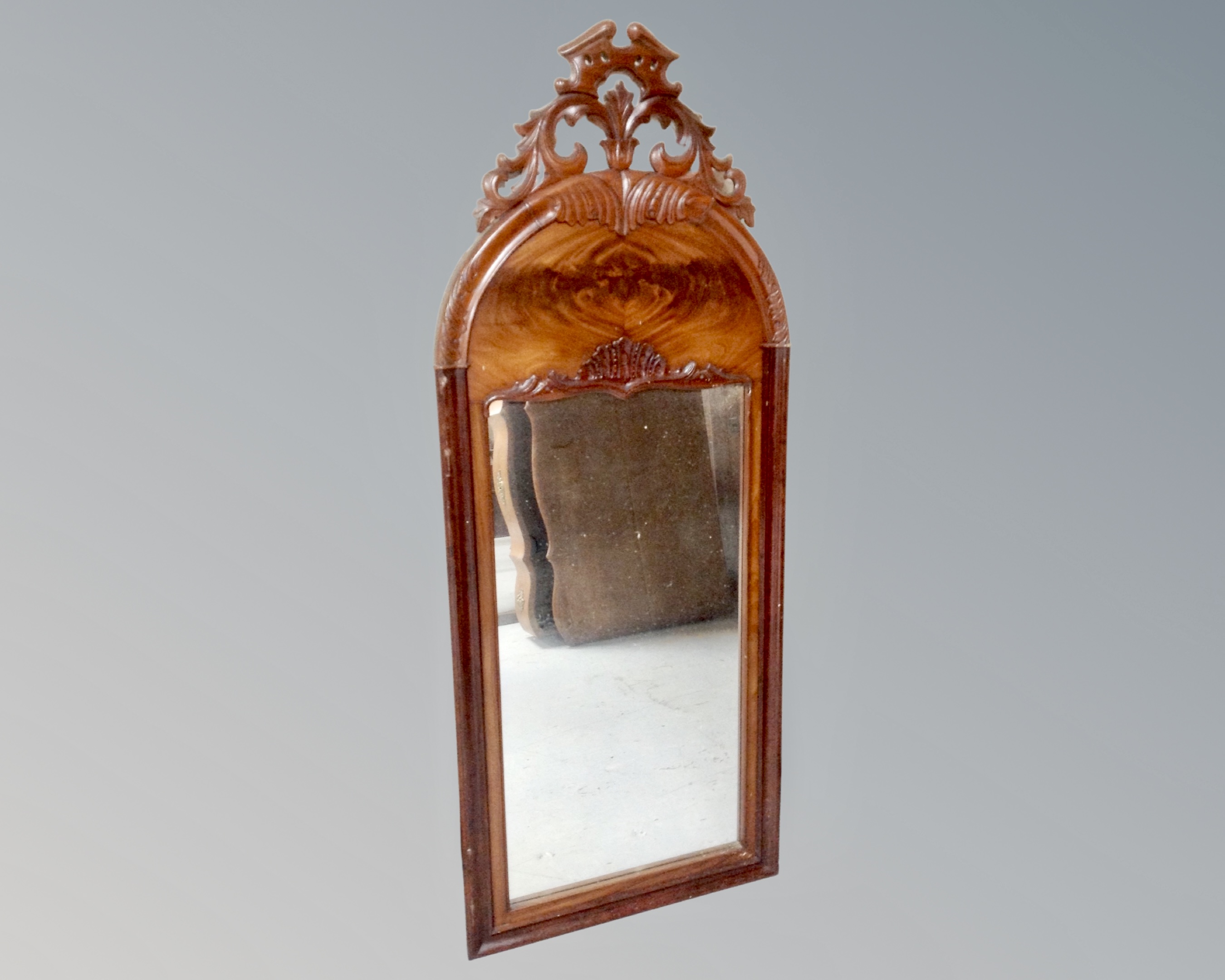 A continental 19th century mahogany mirror with arch top.