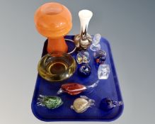 A tray containing glass paperweights, amber glass ashtray, 1970s orange glass table lamp.