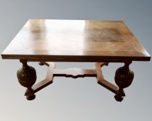 An early 20th century oak extending dining table on bulbous legs