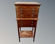 An Edwardian oak five drawer chest with under shelf on raised legs
