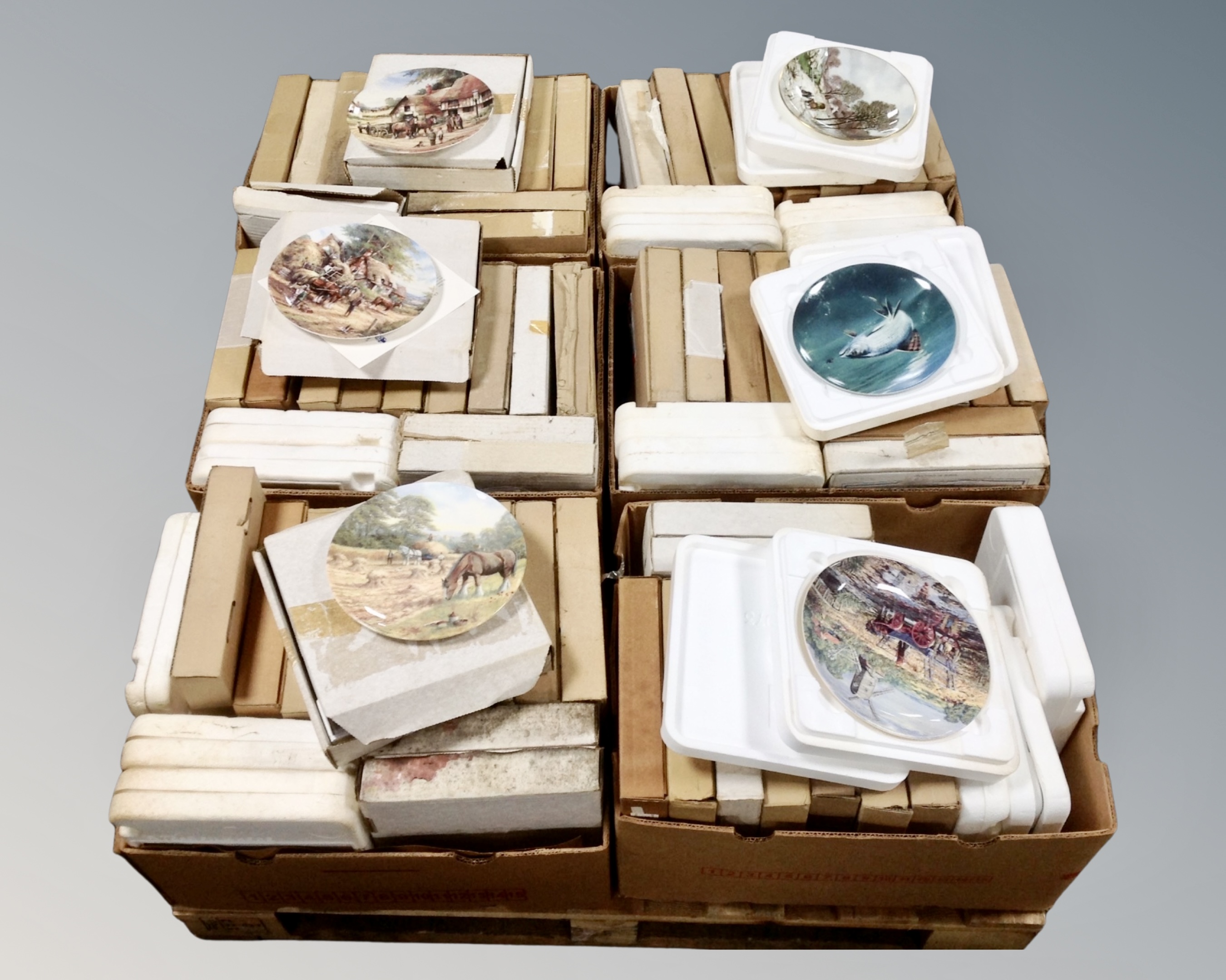 A palette containing approximately 90 boxed collectors plates, including Bradex, Danbury Mint,